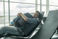 Mature man in airport sleeping at the terminal Royalty Free Stock Photo
