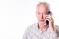 Senior Man in Thoughtful Conversation Over the Phone Royalty Free Stock Photo