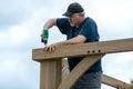 Mature man building wooden construction