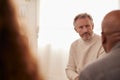 Mature Man Attending Support Group Meeting For Mental Health Or Dependency Issues In Community Space Royalty Free Stock Photo