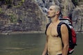 Mature man with backpack at waterfall pongour Royalty Free Stock Photo