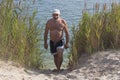 Mature man in a baseball cap and bathing shorts