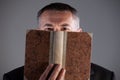 Mature man behind an ancient book Royalty Free Stock Photo