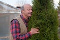 Mature man being proud of his garden hugging his favourite tree Royalty Free Stock Photo