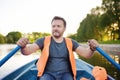 Mature man boating on a river or pond at sunny summer day. Rest and traveling Royalty Free Stock Photo