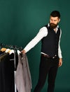 Mature man choosing clothes in fashion shop.