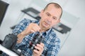 Mature man cleaning lens digital camera with special brush Royalty Free Stock Photo