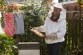 Mature Man Collecting Honey From Hive In Garden