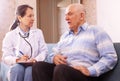 Mature man complaining to doctor about feels