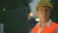 Mature man construction worker at the construction site in the city at night Royalty Free Stock Photo