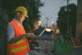 Mature man construction worker at the construction site in the city at night Royalty Free Stock Photo