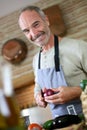 Mature man cooking at home Royalty Free Stock Photo