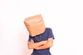 Mature man crestfallen, hiding his identity behind a paper bag over his head