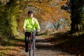 Mature Man Cycling Along Autumn Country Road Royalty Free Stock Photo