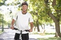 Mature Man Cycling Through Park Royalty Free Stock Photo