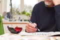 Mature man doing a crossword puzzle and relaxing at home during the day, indoor shot Royalty Free Stock Photo