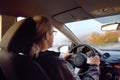 Mature man driver riding a car. Driving by mountain road on autumn day. Inside view Royalty Free Stock Photo