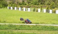 Mature man driving grass cutter in a sunny dGardener driving a riding lawn mower in a gardenay.Worker mowing grass in city park. Royalty Free Stock Photo