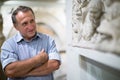 Mature man examines the exhibit in historical museum Royalty Free Stock Photo