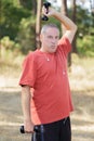 Mature man exercising with dumbbell at park Royalty Free Stock Photo