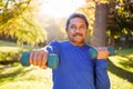 Mature man exercising with dumbbell at park Royalty Free Stock Photo