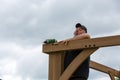 Mature man falling while building wooden pergola