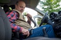 Mature man fastening seat belt in car Royalty Free Stock Photo