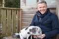 Mature Man Feeding Pet Micro Pig Royalty Free Stock Photo