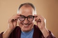 Mature man feeling confident while putting on his glasses Royalty Free Stock Photo