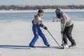 Mature man fighting for the pack while playing hockey on a frozen river Dnepr