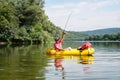 Mature man fishing from the packraft