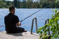 Mature man fishing from pier Royalty Free Stock Photo