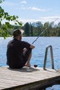 Mature man fishing from pier Royalty Free Stock Photo