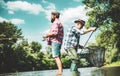 Mature man with friend fishing. Bearded fisher in water. Make with inspiration. Men bearded fishermen. Mature man