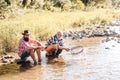 Mature man with friend fishing. Relax in natural environment. Summer weekend. Fish normally caught in wild. Gone fishing