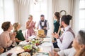 A mature man with friends and family opening presents on a birthday party. Royalty Free Stock Photo