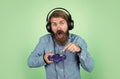 mature man gamer play computer games. guy with beard playing video games. brutal caucasian hipster with moustache. relax Royalty Free Stock Photo