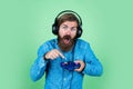 mature man gamer play computer games. guy with beard playing video games. brutal caucasian hipster with moustache. relax Royalty Free Stock Photo