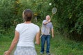 Mature man and girl playing badminton outdoors. Royalty Free Stock Photo