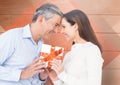 Mature man giving a gift to woman Royalty Free Stock Photo