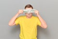 Mature man with glasses is covering his eyes with money Royalty Free Stock Photo