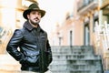 Mature man with hat and jacket standing on stairs with copy space for text Royalty Free Stock Photo