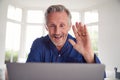 Mature Man Having Online Consultation With Doctor At Home On Laptop