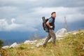 Mature man hiking on mountains. Concepts of adventure, extreme survival, orienteering. Single travel