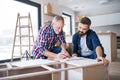 A mature man with his senior father assembling furniture, a new home concept. Royalty Free Stock Photo