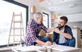 A mature man with his senior father assembling furniture, a new home concept. Royalty Free Stock Photo