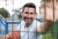 mature man holding basketball