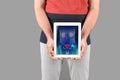 Mature man holding tablet with urinary system