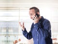 Man inside modern building wearing casual clothes and holding very emotional conversation