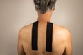 Mature Man with Kinesio Tape on his back for pain Royalty Free Stock Photo